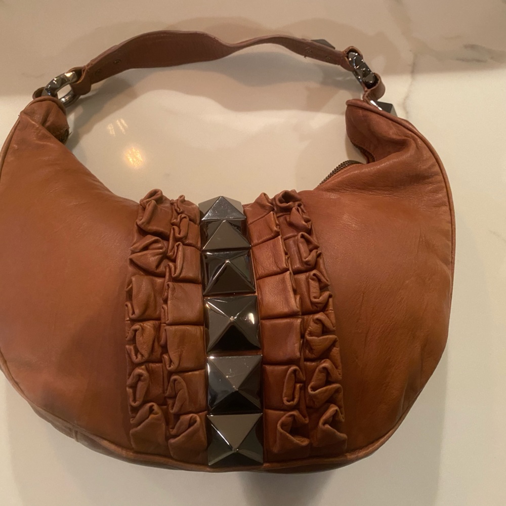 Betsey Johnson crescent shaped brown leather bag with silver studs and ruffles
